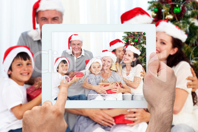 Composite image of hand holding tablet pc