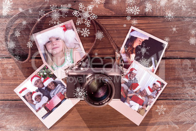 Composite image of girl wearing santa hat at home