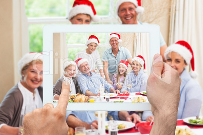 Composite image of hand holding tablet pc