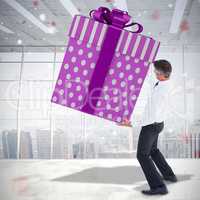 Composite image of stylish man with giant gift