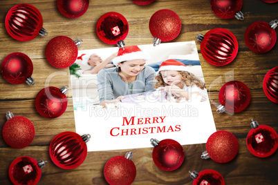 Composite image of christmas baubles on table