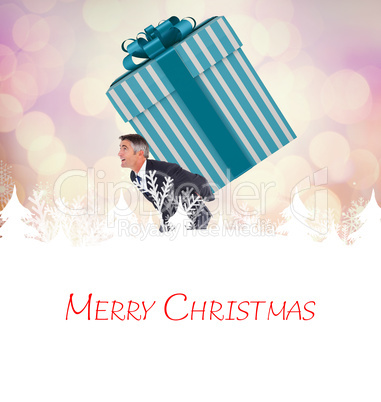 Composite image of stylish man with giant gift