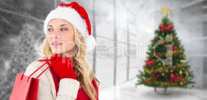 Composite image of happy festive blonde with shopping bag