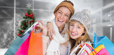 Composite image of smiling women looking at camera with shopping