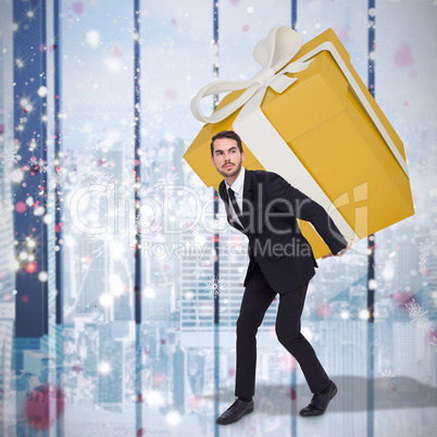 Composite image of stylish man with giant gift