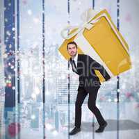 Composite image of stylish man with giant gift