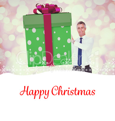 Composite image of stylish man with giant gift