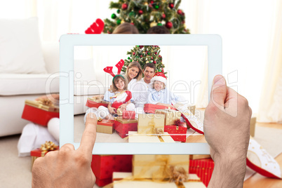 Composite image of hand holding tablet pc