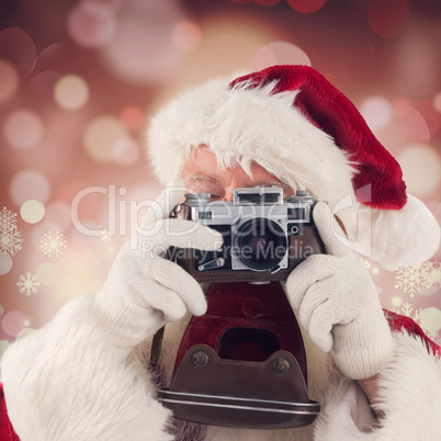 Composite image of santa is taking a picture