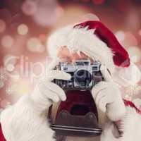 Composite image of santa is taking a picture