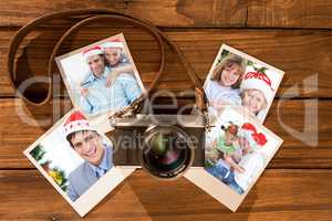 Composite image of cute couple in santa hats shopping online with laptop