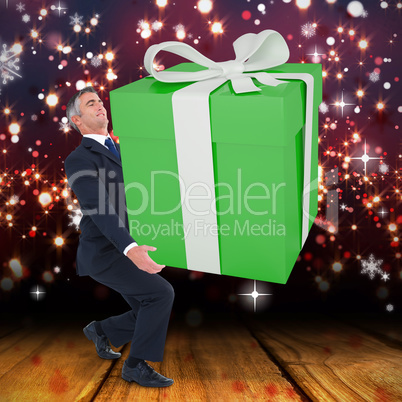 Composite image of stylish man with giant gift