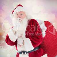 Composite image of santa asking for quiet with bag