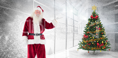 Composite image of santa shows something to camera