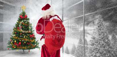 Composite image of santa is holding his bag in one hand