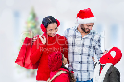 Composite image of happy family looking at each other