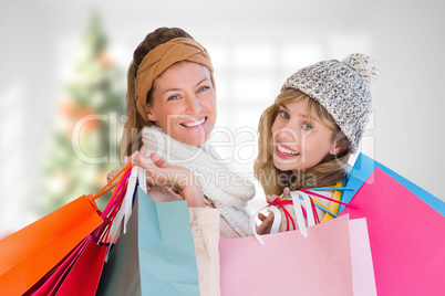 Composite image of beautiful women holding shopping bags looking