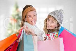 Composite image of beautiful women holding shopping bags looking