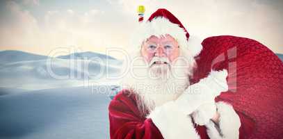 Composite image of jolly santa carries his sack