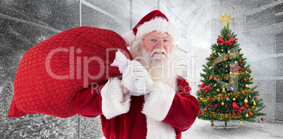 Composite image of santa carries his red bag and smiles