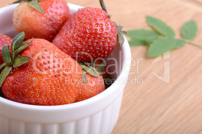 Close up strawberry on wooden plate