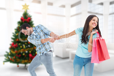 Composite image of happy couple with shopping bag