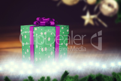 A green christmas present with purple ribbon