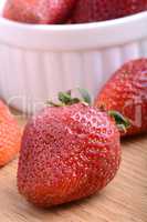 Strawberry set on wooden plate close up