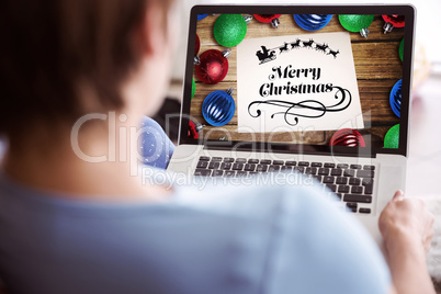 Composite image of pregnant woman using her laptop