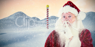 Composite image of santa asking for quiet to camera