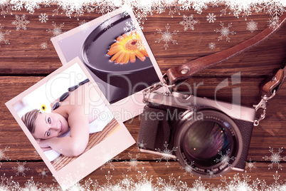 Composite image of glowing young woman with hot stone on her bac