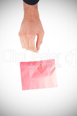 A Hand holding a gift bag