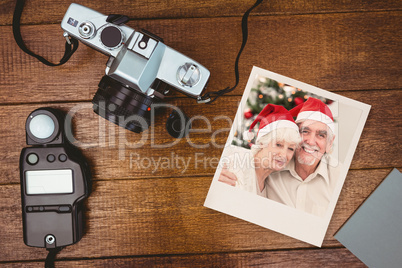 Composite image of happy couple on the couch at christmas