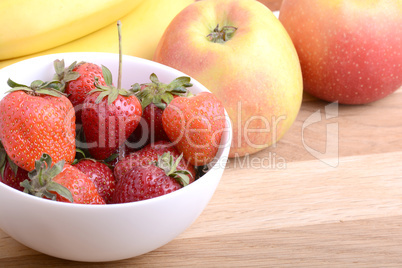 Close-up shot of variety of fruits on old wooden plate