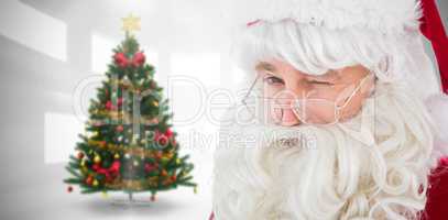 Composite image of portrait of santa claus winking