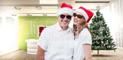 Composite image of festive couple smiling at camera