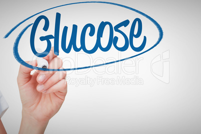 Glucose against female hand holding whiteboard marker