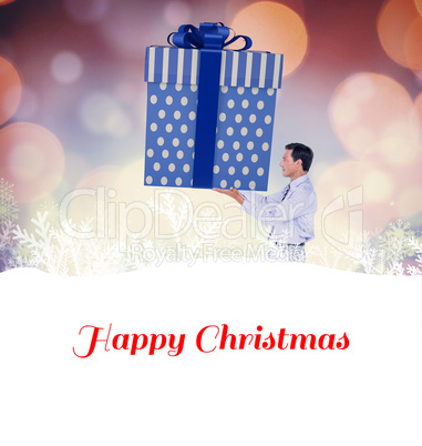 Composite image of stylish man with giant gift