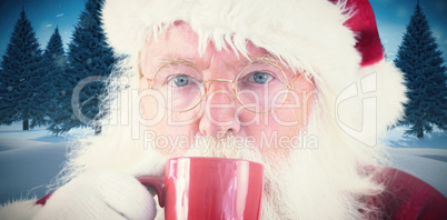 Composite image of santa drinks from a red cup