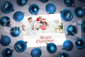 Composite image of christmas baubles on table