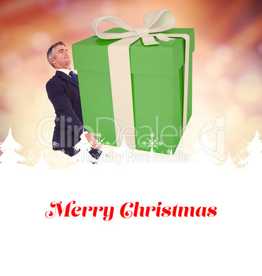 Composite image of stylish man with giant gift