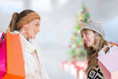 Composite image of smiling women looking at each other with shop