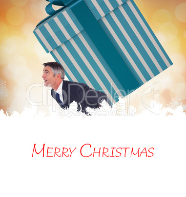 Composite image of stylish man with giant gift