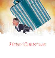 Composite image of stylish man with giant gift