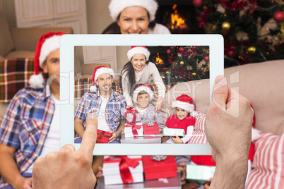 Composite image of hand holding tablet pc