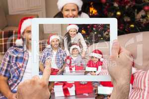 Composite image of hand holding tablet pc