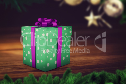 A green christmas present with purple ribbon