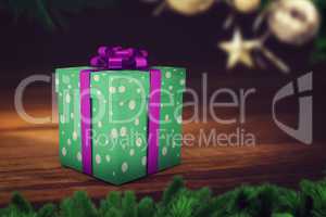 A green christmas present with purple ribbon