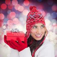 Composite image of happy brown hair holding red gift