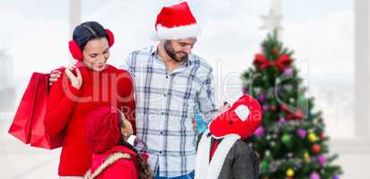 Composite image of happy family looking at each other